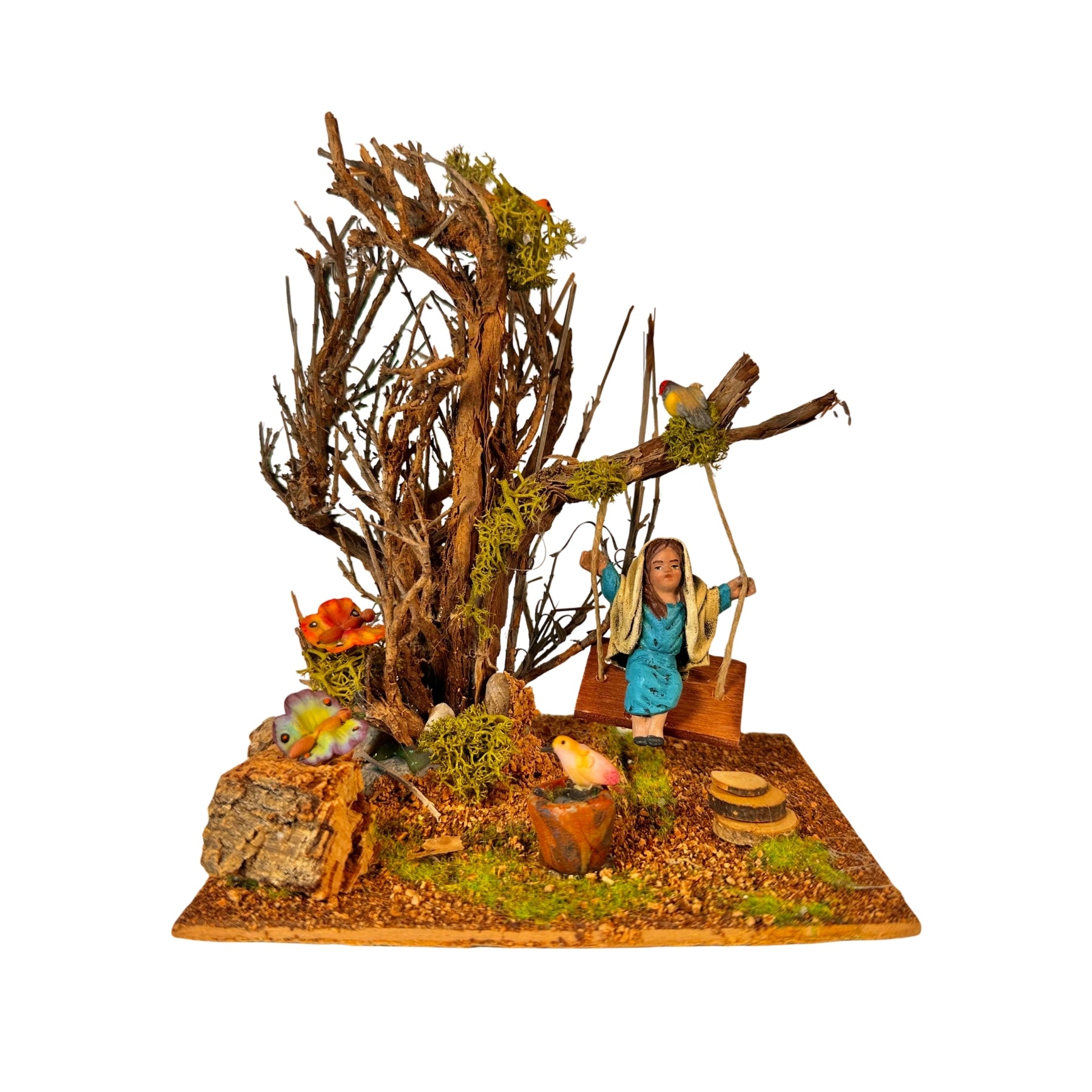 Árbol con columpio y niña de barro