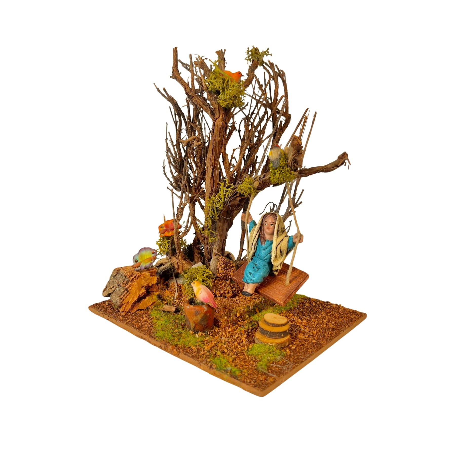Árbol con columpio y niña de barro