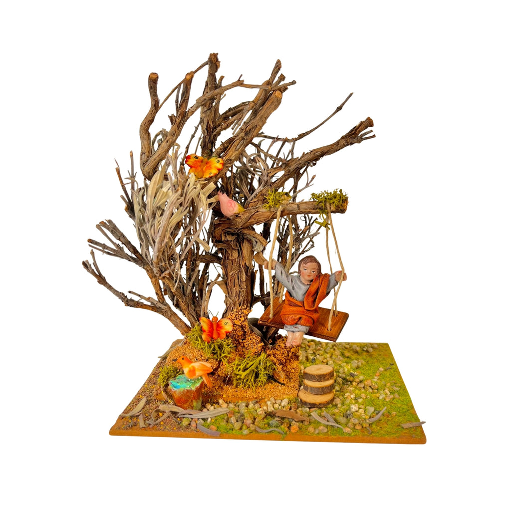 Belenes Artesanos - Árbol con columpio y niño de barro